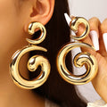 Mira Earrings – Sculptural Spiral Drop Earrings in Gold | ÉLAN by AKI